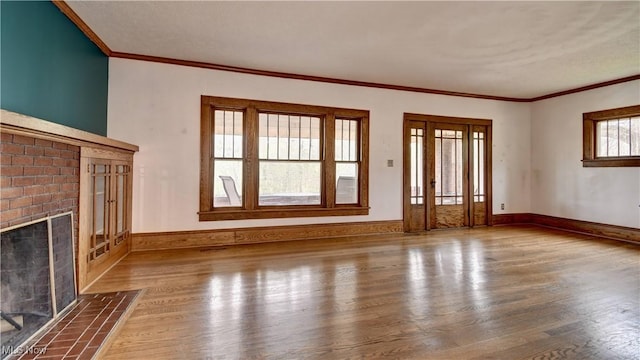 6456 Dover Zoar Rd NE, Dover, OH 44622 - unfurnished living room with wood finished floors, a fireplace, ornamental molding, and baseboards