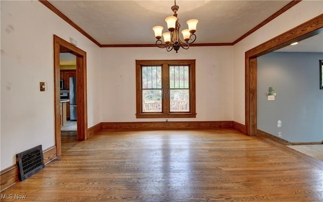 6456 Dover Zoar Rd NE, Dover, OH 44622 - unfurnished dining area featuring wood finished floors, a chandelier, baseboards, and ornamental molding