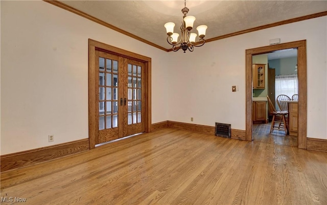 6456 Dover Zoar Rd NE, Dover, OH 44622 - empty room with wood finished floors, french doors, a chandelier, crown molding, and baseboards