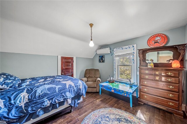 2226 W 13th St, Ashtabula, OH 44004 - bedroom with vaulted ceiling, an AC wall unit, and dark wood finished floors