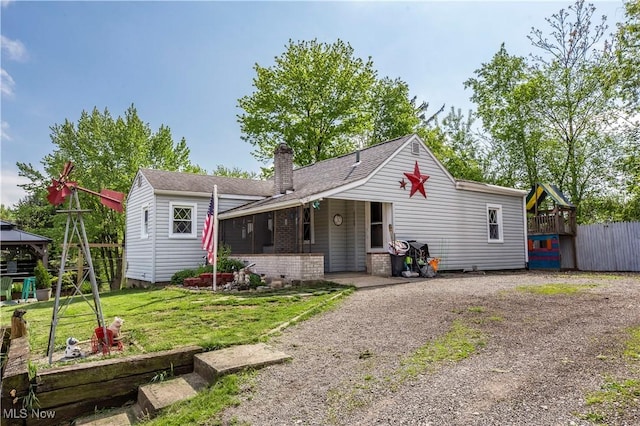 2229 41st St NW, Canton, OH 44709 - view of front of house featuring a chimney, a gazebo, a front lawn, roof with shingles, and dirt driveway