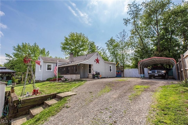 2229 41st St NW, Canton, OH 44709 - view of front of house with dirt driveway, a detached carport, a gazebo, and a chimney