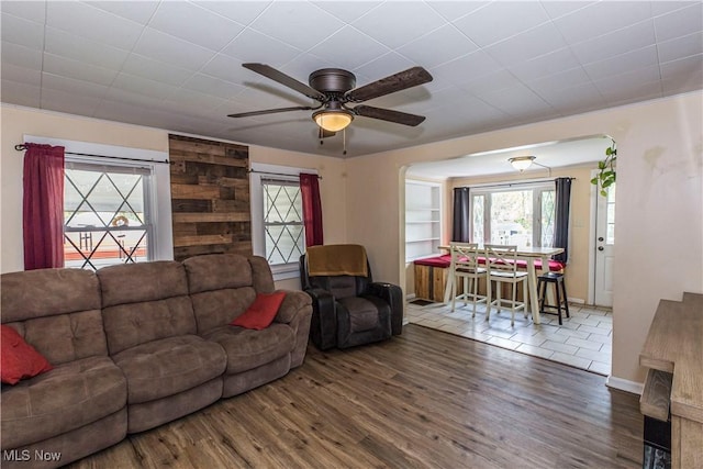 2229 41st St NW, Canton, OH 44709 - living area featuring wood finished floors, ceiling fan, arched walkways, and baseboards