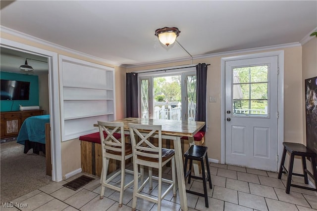 2229 41st St NW, Canton, OH 44709 - dining space featuring light tile patterned floors, crown molding, baseboards, and built in shelves