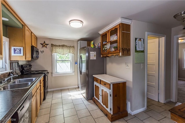 2229 41st St NW, Canton, OH 44709 - kitchen with black appliances, a sink, light tile patterned floors, baseboards, and brown cabinets