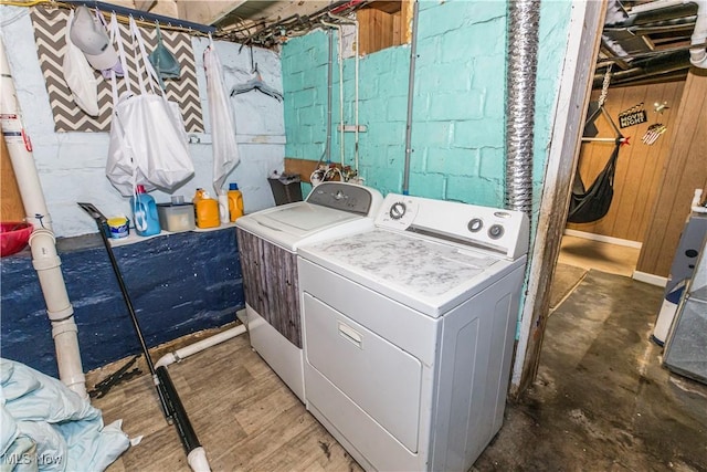 2229 41st St NW, Canton, OH 44709 - clothes washing area with washing machine and dryer and wooden walls