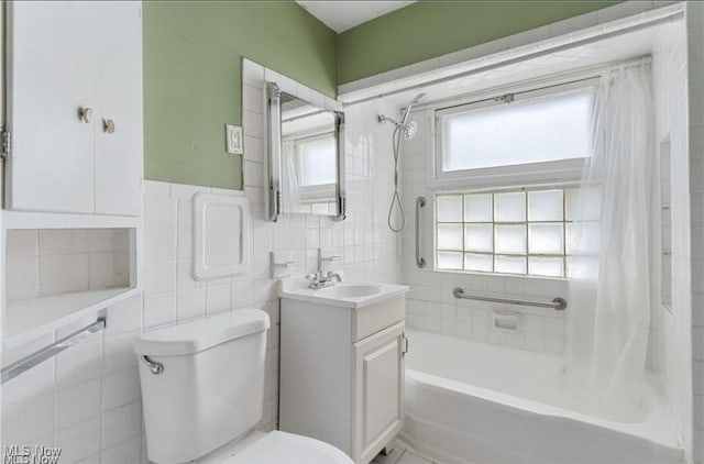 full bath featuring tile walls, shower / bath combo, toilet, and vanity