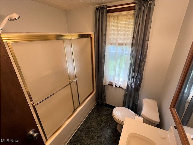2640 W 19th St, Ashtabula, OH 44004 - full bathroom featuring toilet and bath / shower combo with glass door