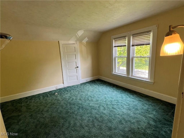 2640 W 19th St, Ashtabula, OH 44004 - bonus room featuring vaulted ceiling, a textured ceiling, carpet flooring, and baseboards