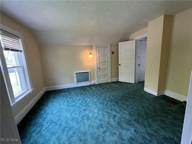 2640 W 19th St, Ashtabula, OH 44004 - unfurnished living room featuring lofted ceiling, baseboards, dark colored carpet, and a textured ceiling