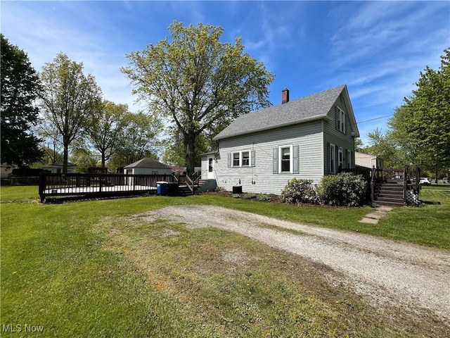 2640 W 19th St, Ashtabula, OH 44004 - view of home's exterior with a wooden deck, a chimney, a yard, and a shingled roof