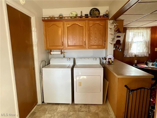 clothes washing area featuring washer and dryer and baseboards