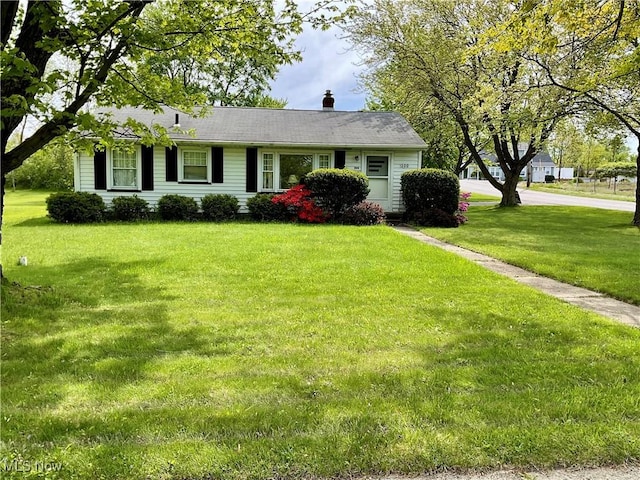 view of front of property with a front lawn and a chimney
