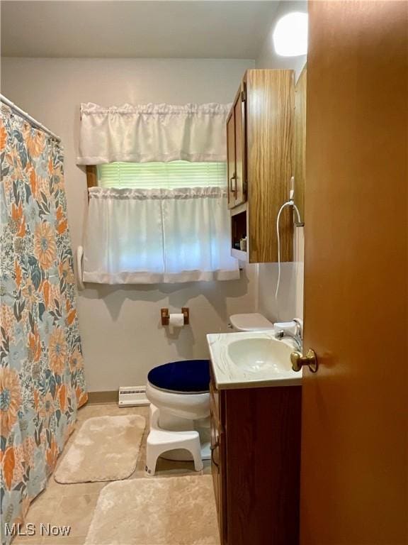 full bath featuring baseboard heating, vanity, toilet, tile patterned flooring, and a shower with curtain
