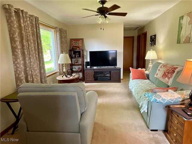 living room featuring light carpet and ceiling fan