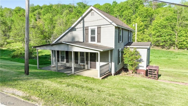 59969 Somerton Hwy, Barnesville, OH 43713 - back of property featuring a lawn, a patio area, a shingled roof, and a wooded view