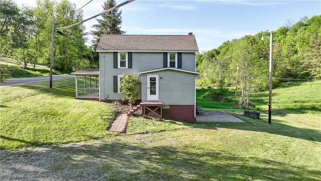 59969 Somerton Hwy, Barnesville, OH 43713 - rear view of house featuring a yard and a chimney
