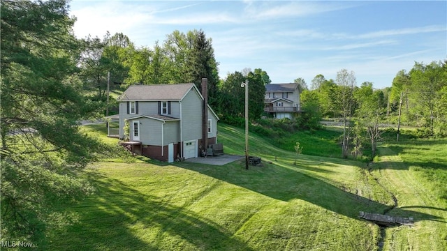 59969 Somerton Hwy, Barnesville, OH 43713 - view of property exterior with an attached garage, a chimney, a yard, and a patio