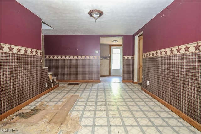 59969 Somerton Hwy, Barnesville, OH 43713 - entrance foyer featuring tile walls, a wainscoted wall, tile patterned floors, and a textured ceiling