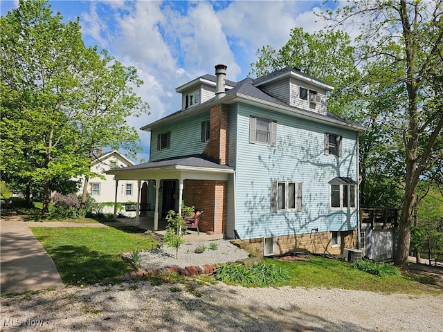 164 W High St, New Concord, OH 43762 - view of front of house featuring a chimney, a patio area, and central AC unit