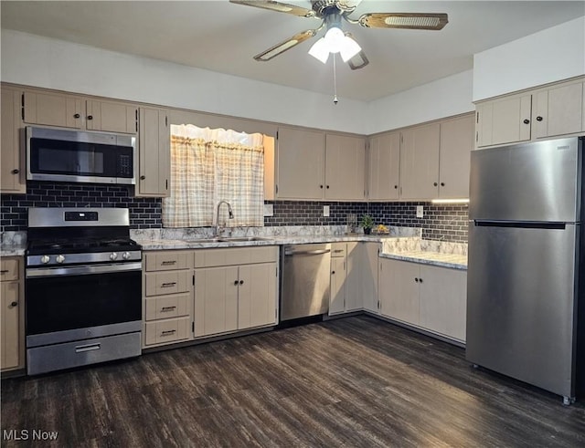 164 W High St, New Concord, OH 43762 - kitchen with appliances with stainless steel finishes, a sink, dark wood-type flooring, decorative backsplash, and ceiling fan