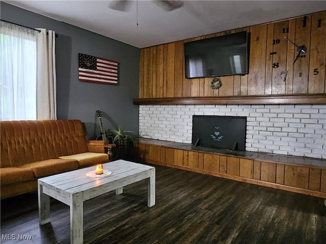 164 W High St, New Concord, OH 43762 - living area with dark wood-type flooring, ceiling fan, and wooden walls