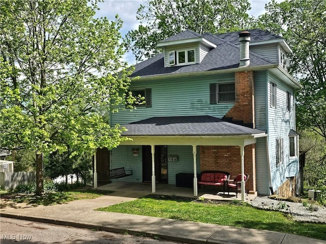 164 W High St, New Concord, OH 43762 - traditional style home featuring a shingled roof, a patio, and an outdoor living space
