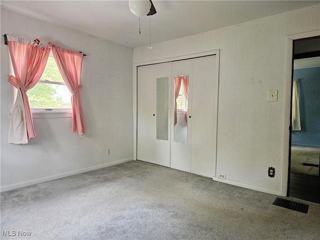 164 W High St, New Concord, OH 43762 - unfurnished bedroom with carpet, a closet, baseboards, and a ceiling fan