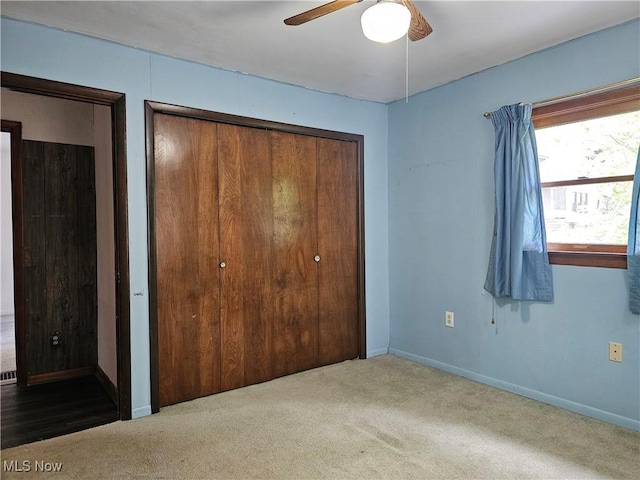 164 W High St, New Concord, OH 43762 - unfurnished bedroom featuring carpet flooring, baseboards, ceiling fan, and a closet