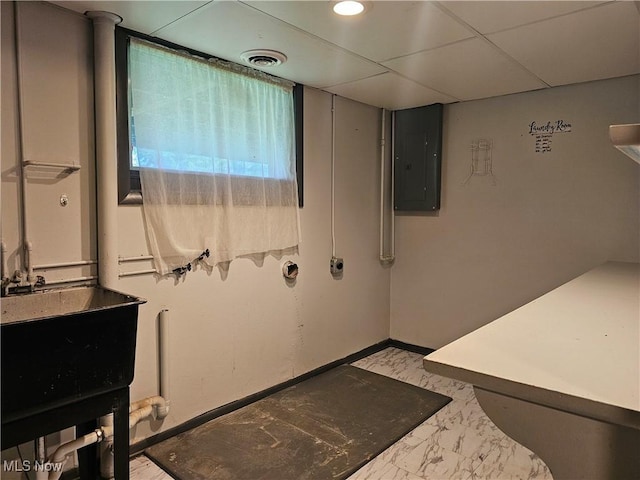 164 W High St, New Concord, OH 43762 - laundry room featuring electric panel, baseboards, and light marble finish flooring