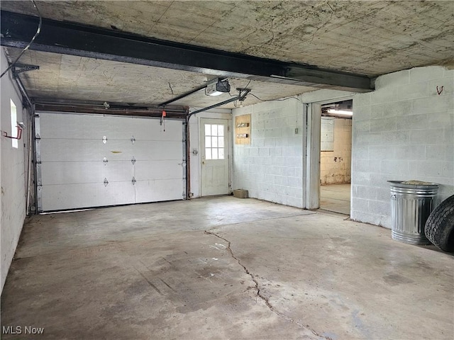 164 W High St, New Concord, OH 43762 - garage featuring a garage door opener and concrete block wall