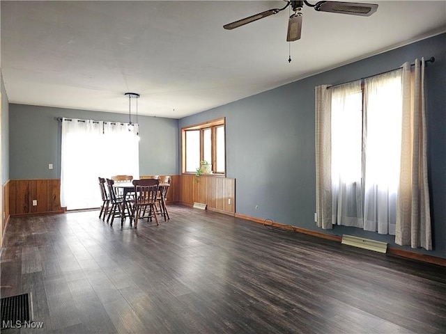 164 W High St, New Concord, OH 43762 - dining area with ceiling fan, dark wood finished floors, wainscoting, wooden walls, and baseboards
