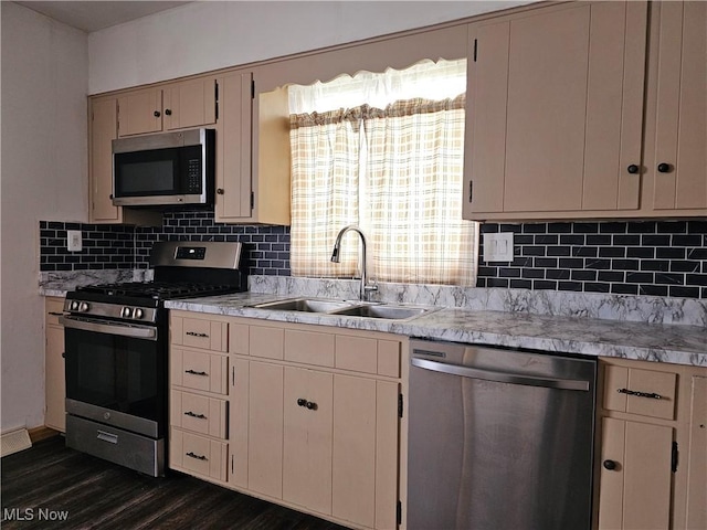 164 W High St, New Concord, OH 43762 - kitchen featuring appliances with stainless steel finishes, a sink, light countertops, backsplash, and dark wood-style flooring