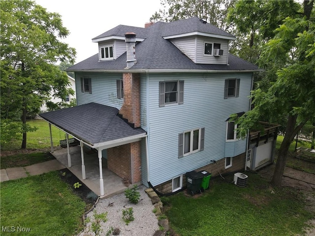 164 W High St, New Concord, OH 43762 - rear view of property featuring a lawn, a chimney, and a shingled roof