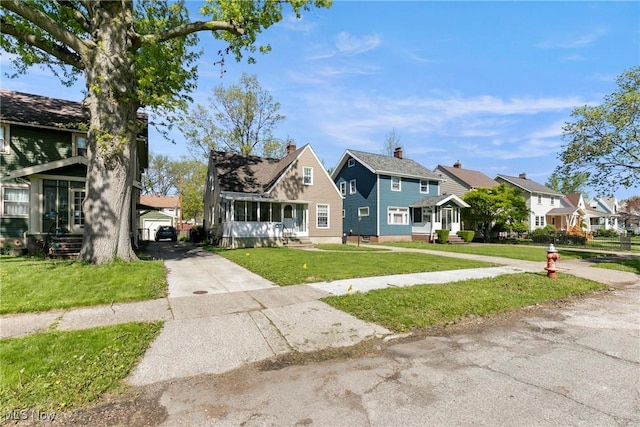4414 W 171st St, Cleveland, OH 44135 - view of front of property with a residential view, a front yard, and concrete driveway