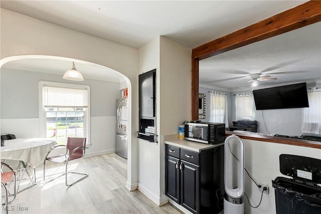 4414 W 171st St, Cleveland, OH 44135 - kitchen featuring arched walkways, stainless steel fridge, a ceiling fan, light wood-style floors, and dark cabinets