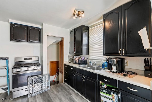 4414 W 171st St, Cleveland, OH 44135 - kitchen with gas stove, a sink, dark cabinetry, and light countertops