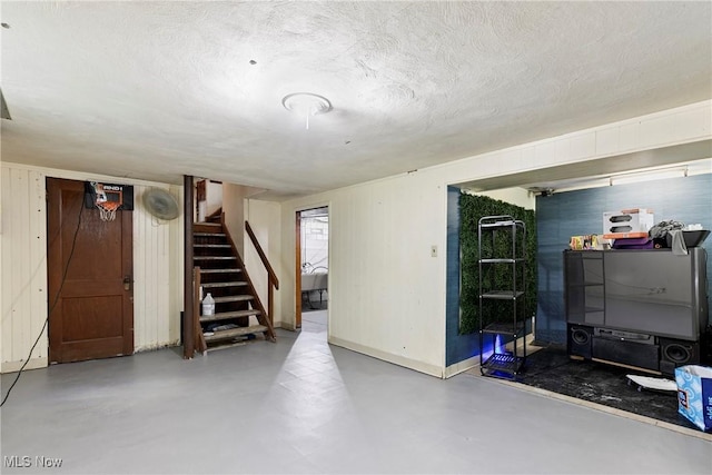 4414 W 171st St, Cleveland, OH 44135 - finished below grade area featuring stairs, a textured ceiling, and baseboards