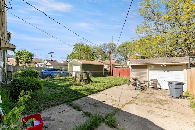 4414 W 171st St, Cleveland, OH 44135 - view of yard featuring driveway, a detached garage, an outbuilding, and a patio area