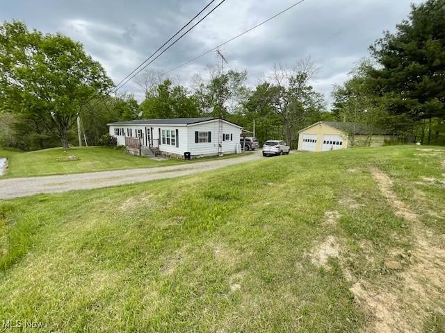 38722 State Route 518th Rd, Lisbon, OH 44432 - view of front of house with a garage, a front yard, and view of scattered trees
