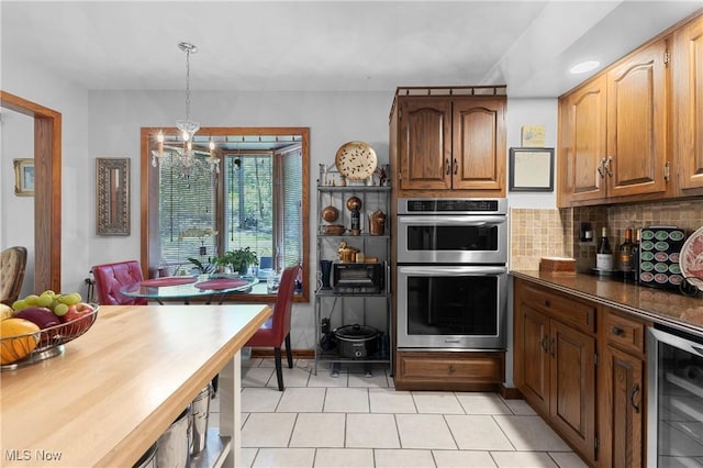 359 Boyce Dr, Chester, WV 26034 - kitchen featuring beverage cooler, stainless steel double oven, a chandelier, light tile patterned floors, and tasteful backsplash