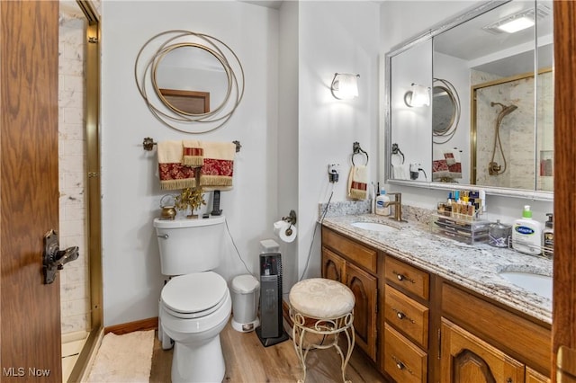 359 Boyce Dr, Chester, WV 26034 - bathroom with toilet, a shower stall, wood finished floors, and double vanity
