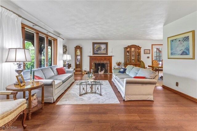 359 Boyce Dr, Chester, WV 26034 - living room with hardwood / wood-style flooring, a brick fireplace, and baseboards