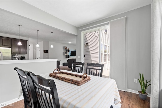 dining room with baseboards and wood finished floors