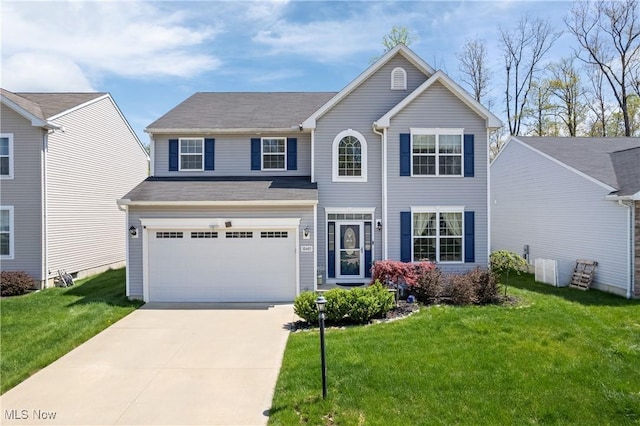 view of front of house with an attached garage, a front yard, and driveway