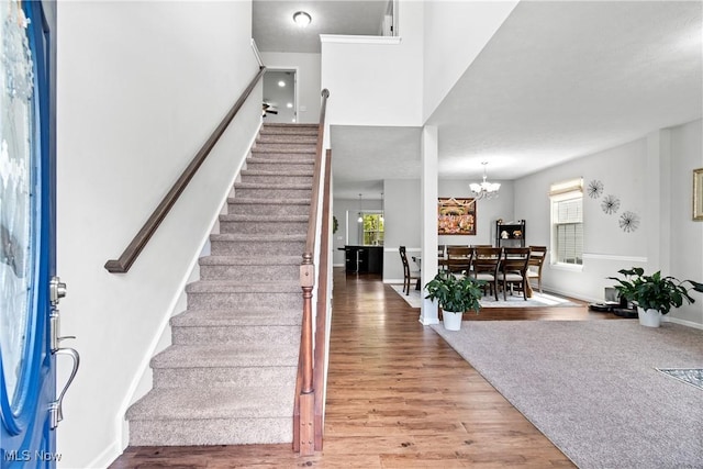 entrance foyer with stairs, wood finished floors, and plenty of natural light