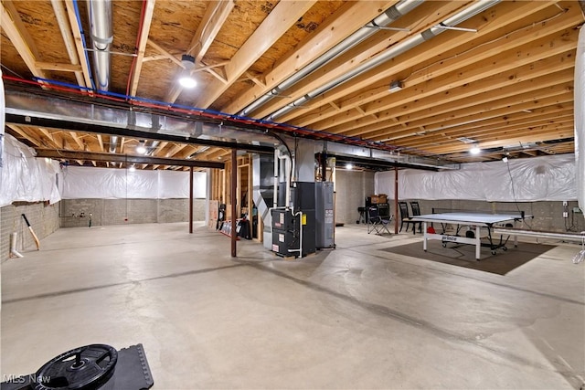 unfinished basement with water heater and heating unit