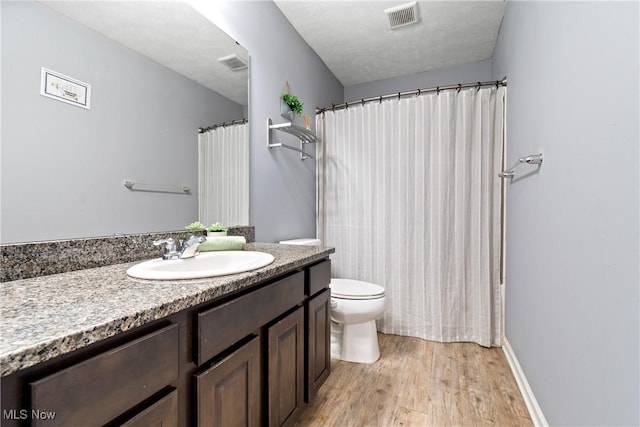 full bath featuring vanity, wood finished floors, toilet, and a shower with shower curtain