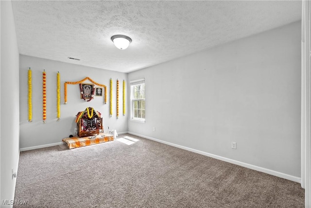 playroom with carpet flooring, baseboards, and a textured ceiling