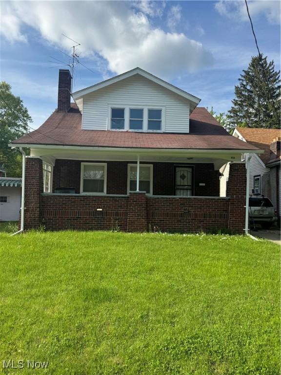 510 Parkcliffe Ave, Youngstown, OH 44511 - bungalow-style house with covered porch, a front yard, and brick siding